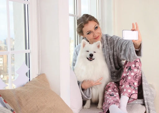 pet owner taking a selfie with her canine
